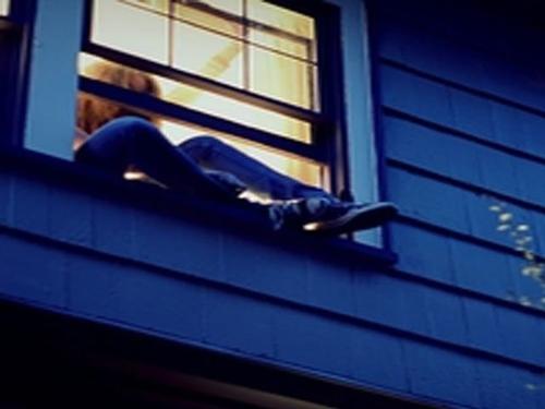 girl crawling out of window